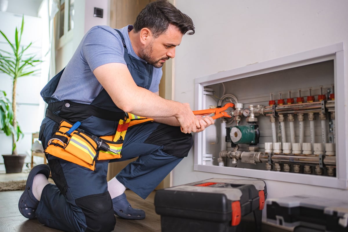 Plumber installing underfloor heating in a modern home